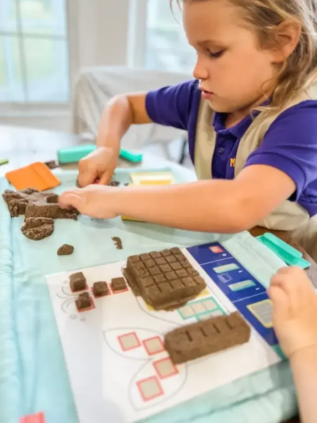 kids playing with modeling sand and wipable mat which we love